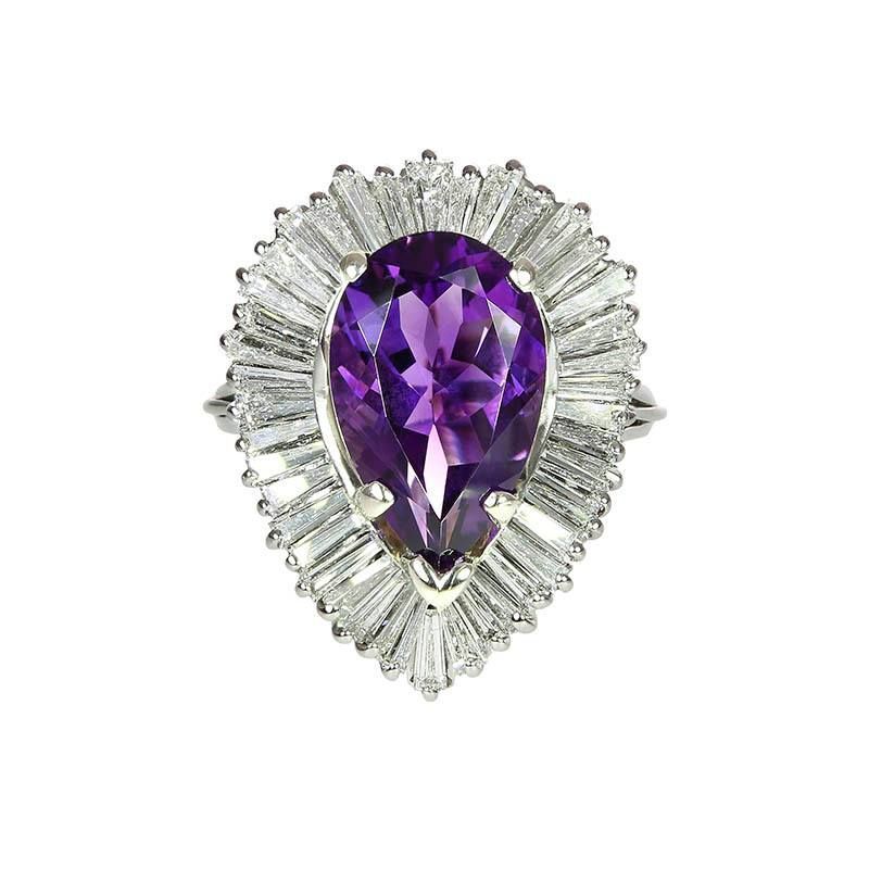 Purple pear-cut gemstone ring with a halo of clear baguette stones