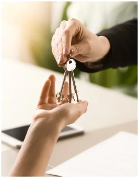 A person is handing a set of keys to another person.