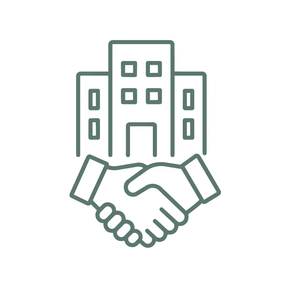 Handshake in front of office buildings, symbolizing a business partnership.