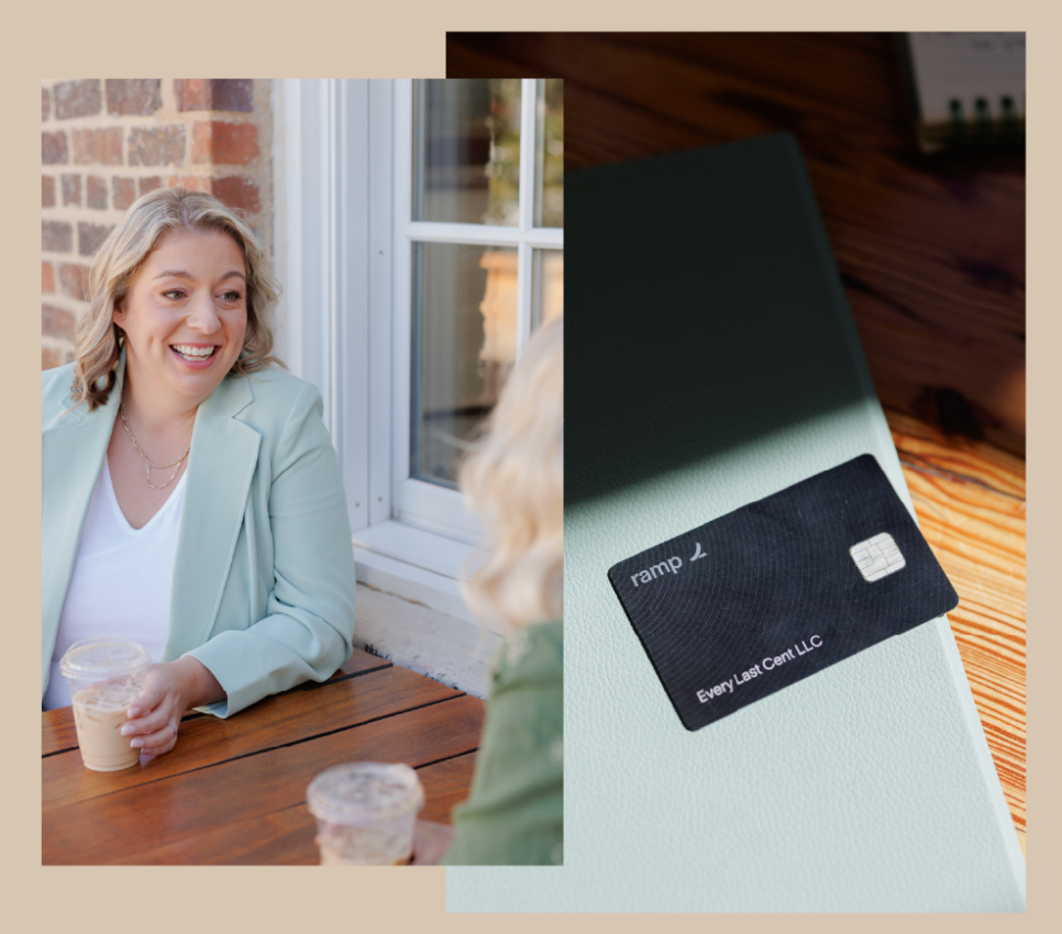 Two women talking at a patio table beside a window, with a black credit card on a laptop nearby