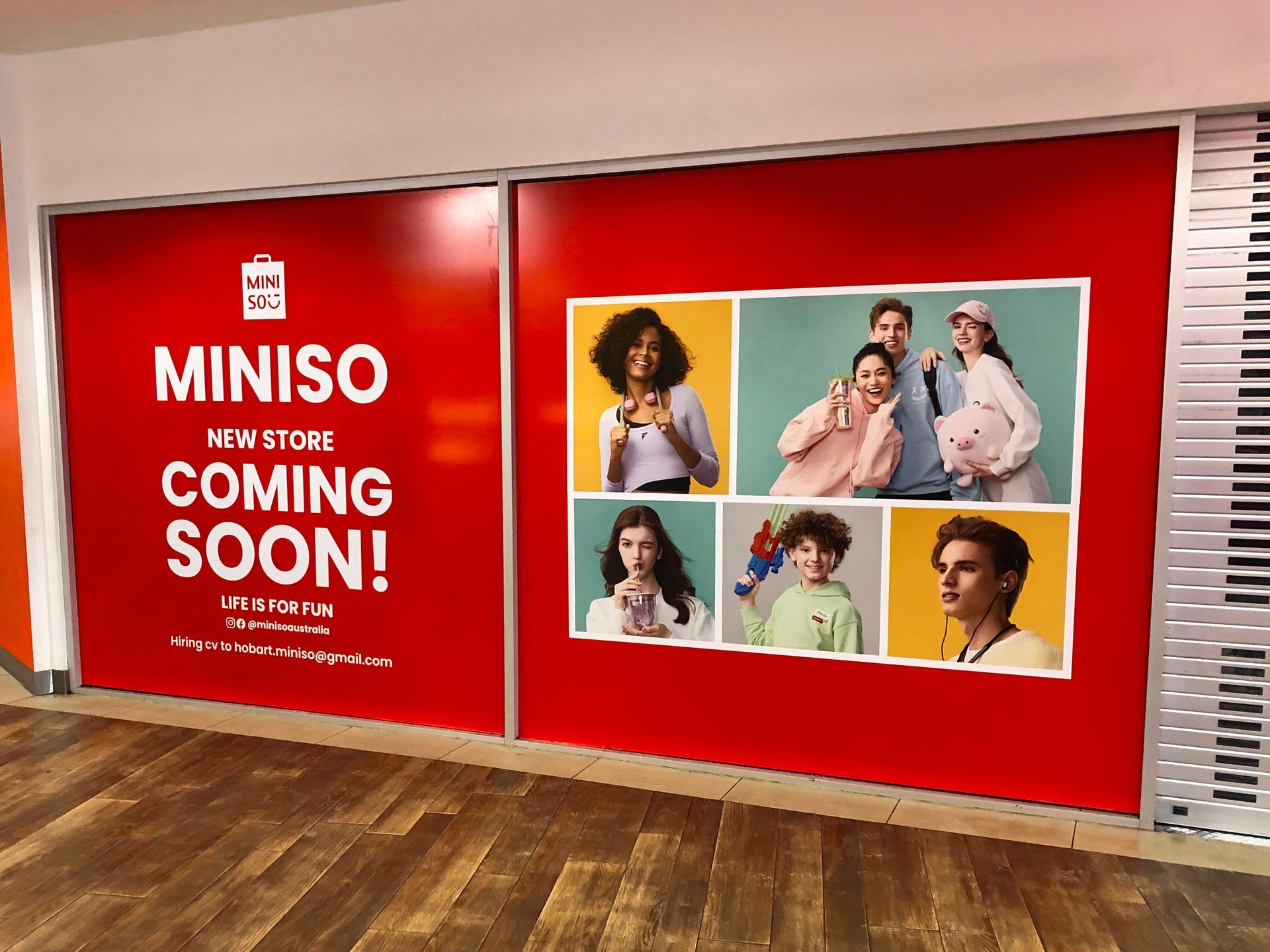 MINISO store coming soon sign, red background, photos of people, white text.