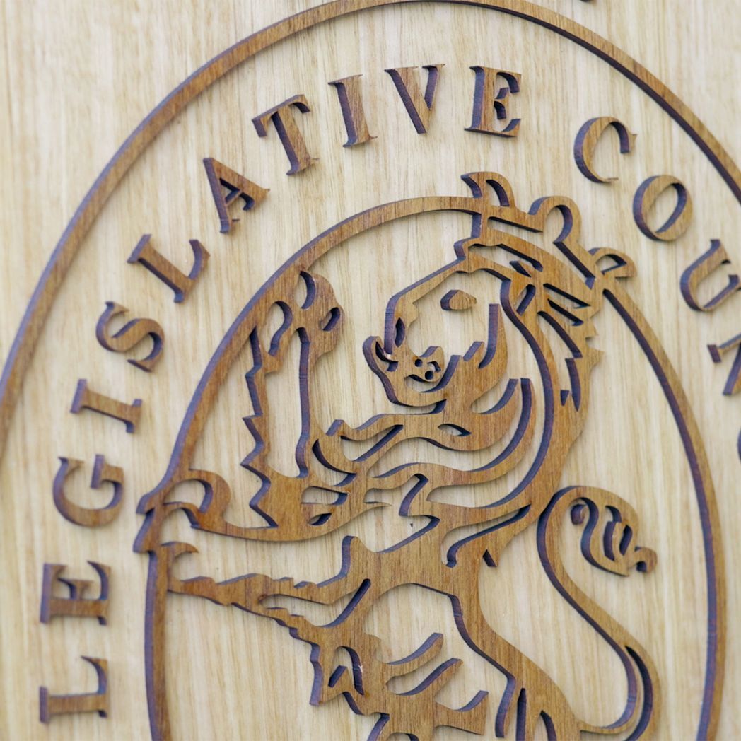 Carved wooden emblem with