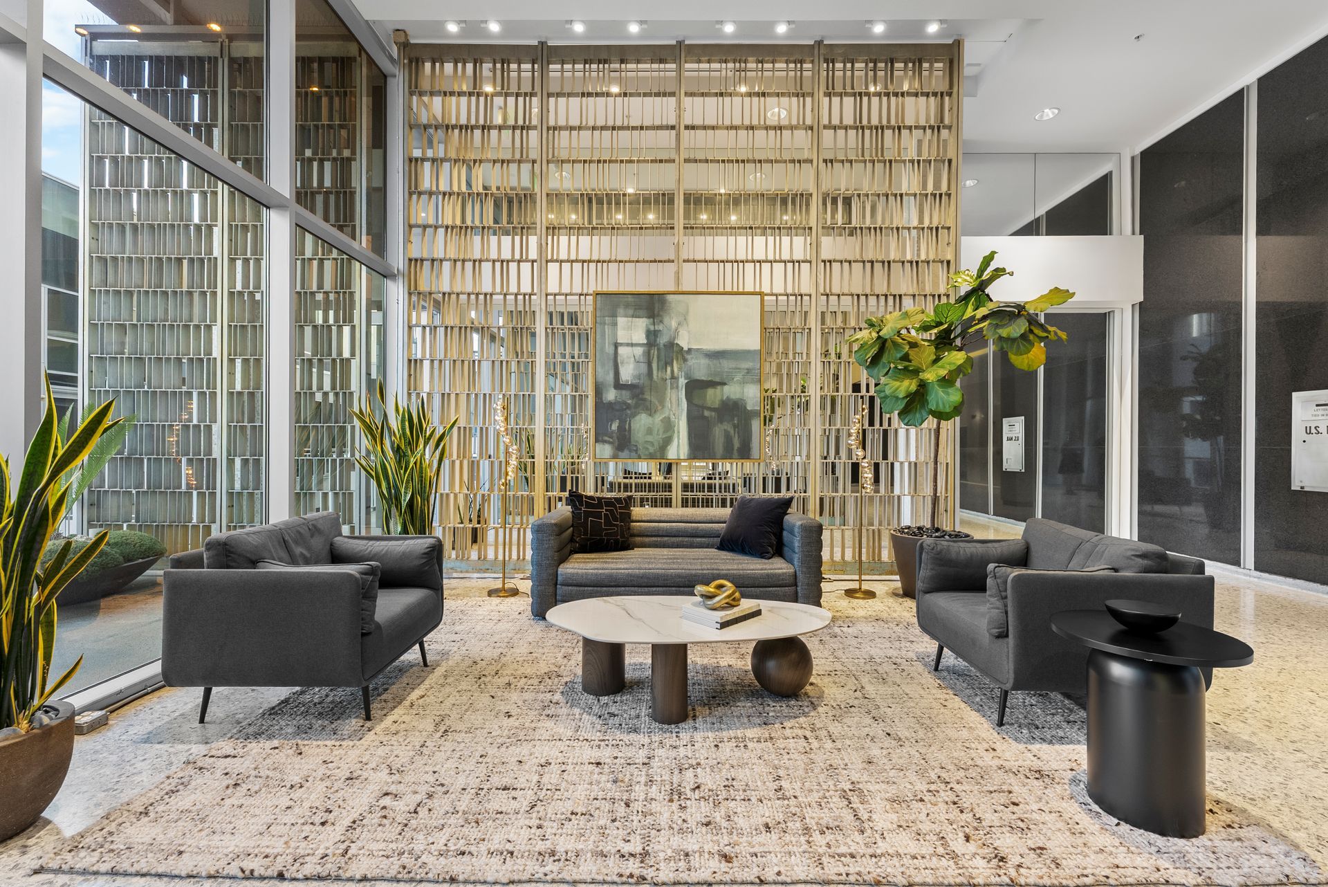 geometric wall with black couches and table
