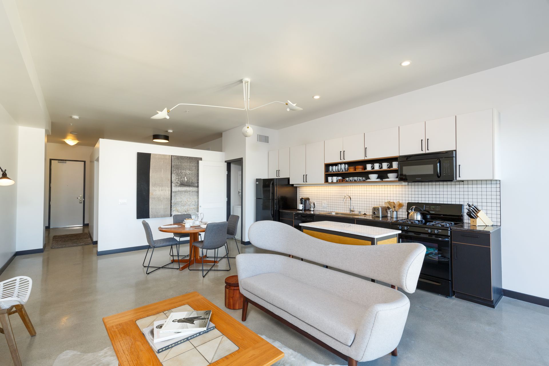 Internal Photo of Living Room with Kitchen in Background
