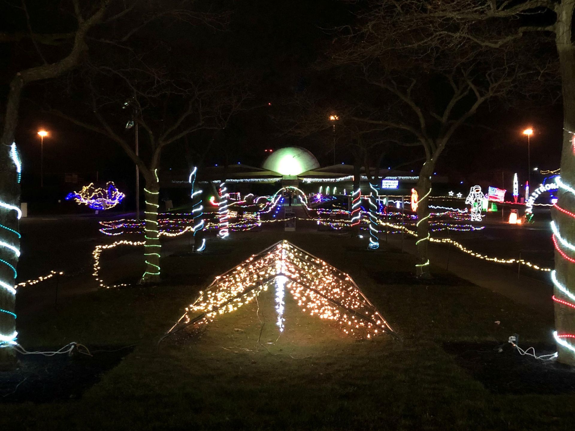The exterior of the Armstrong Air & Space Museum with holiday lights illuminated.