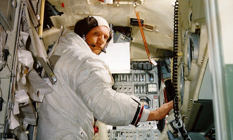 Astronaut Neil Armstrong training in a lunar module mockup.