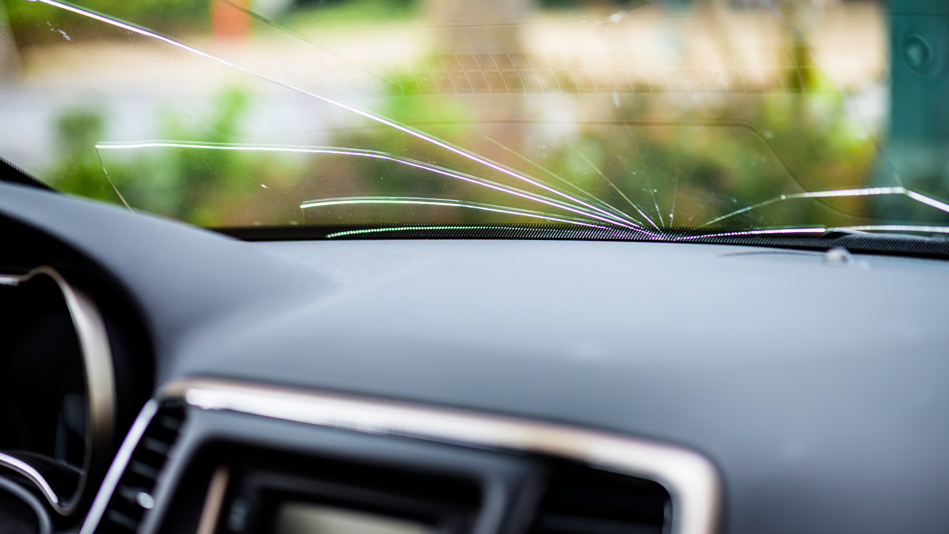A close up of a broken windshield in a car.