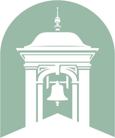 A white building with a bell on top of it.