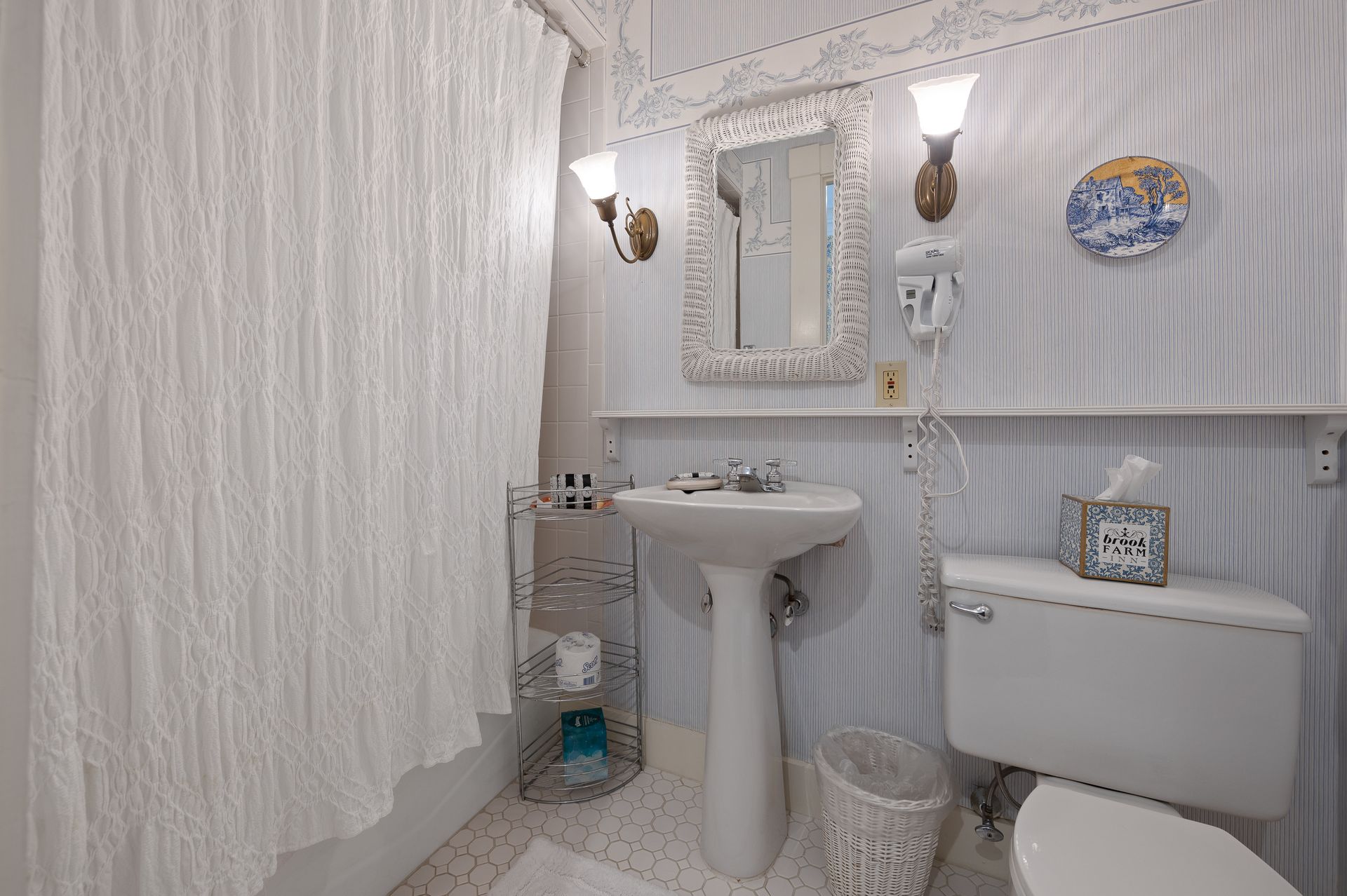 A bathroom with a sink , toilet and mirror.