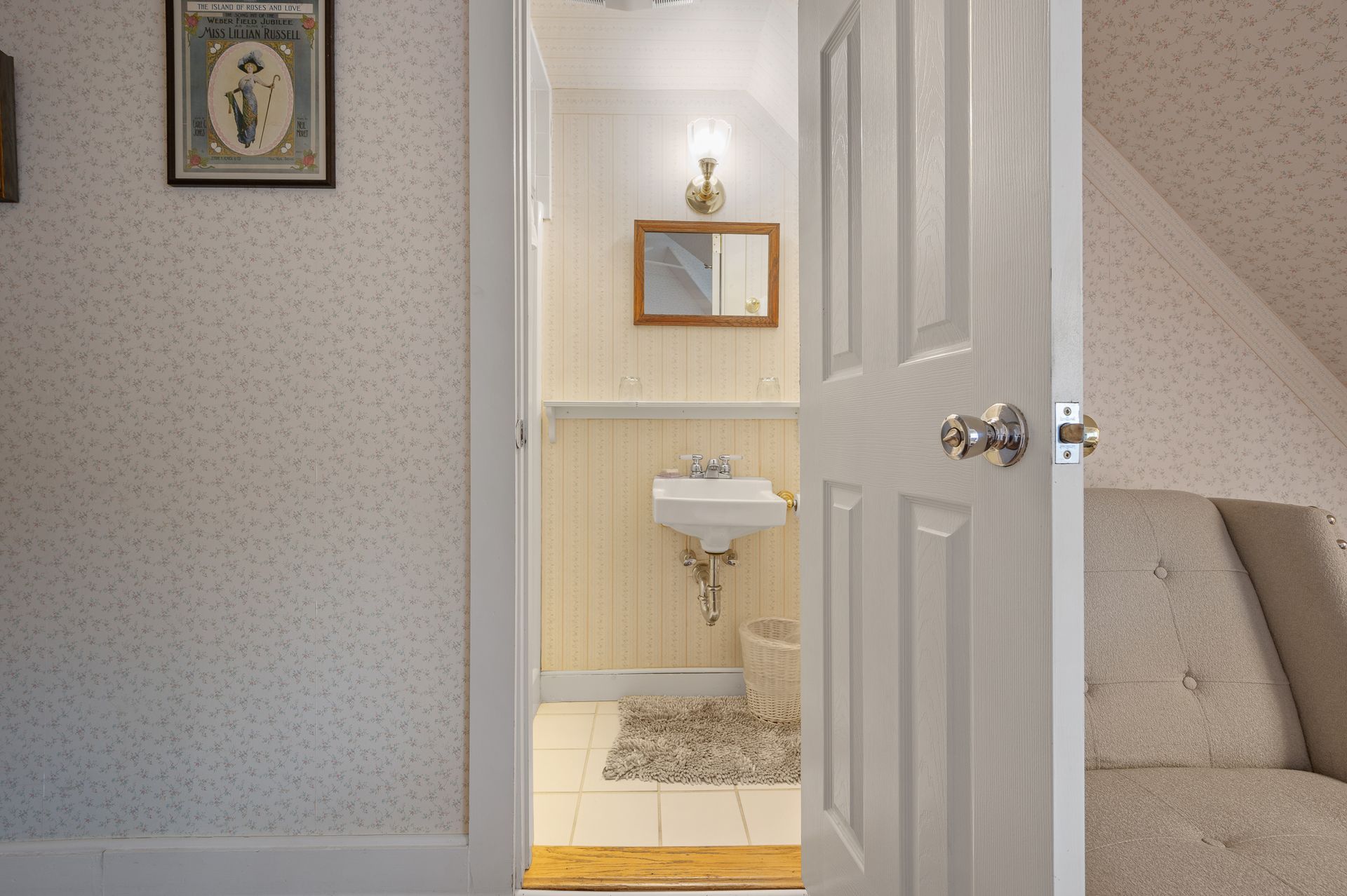 A bathroom with a sink and a mirror on the wall
