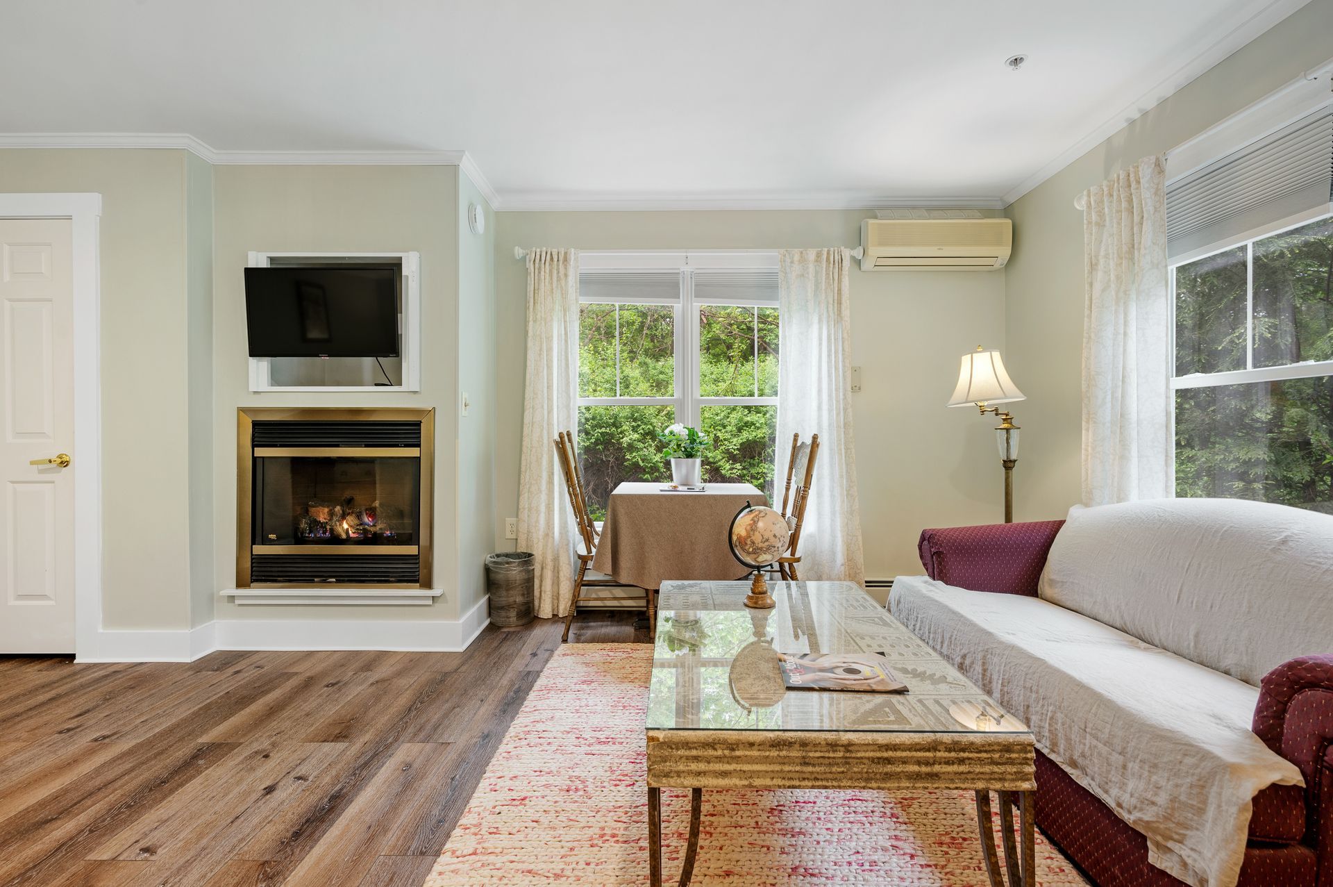 A living room with a couch , table , fireplace and television.