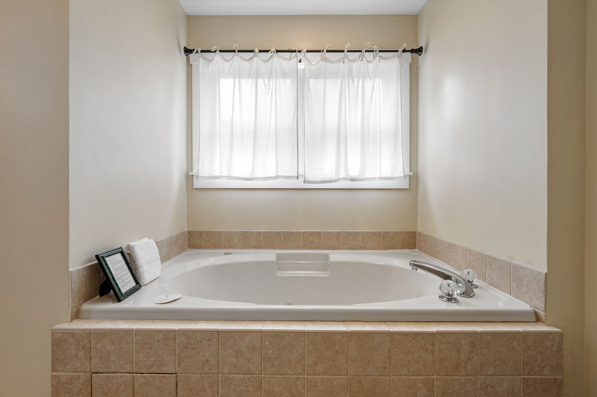 There is a large jacuzzi tub in the middle of the bathroom.