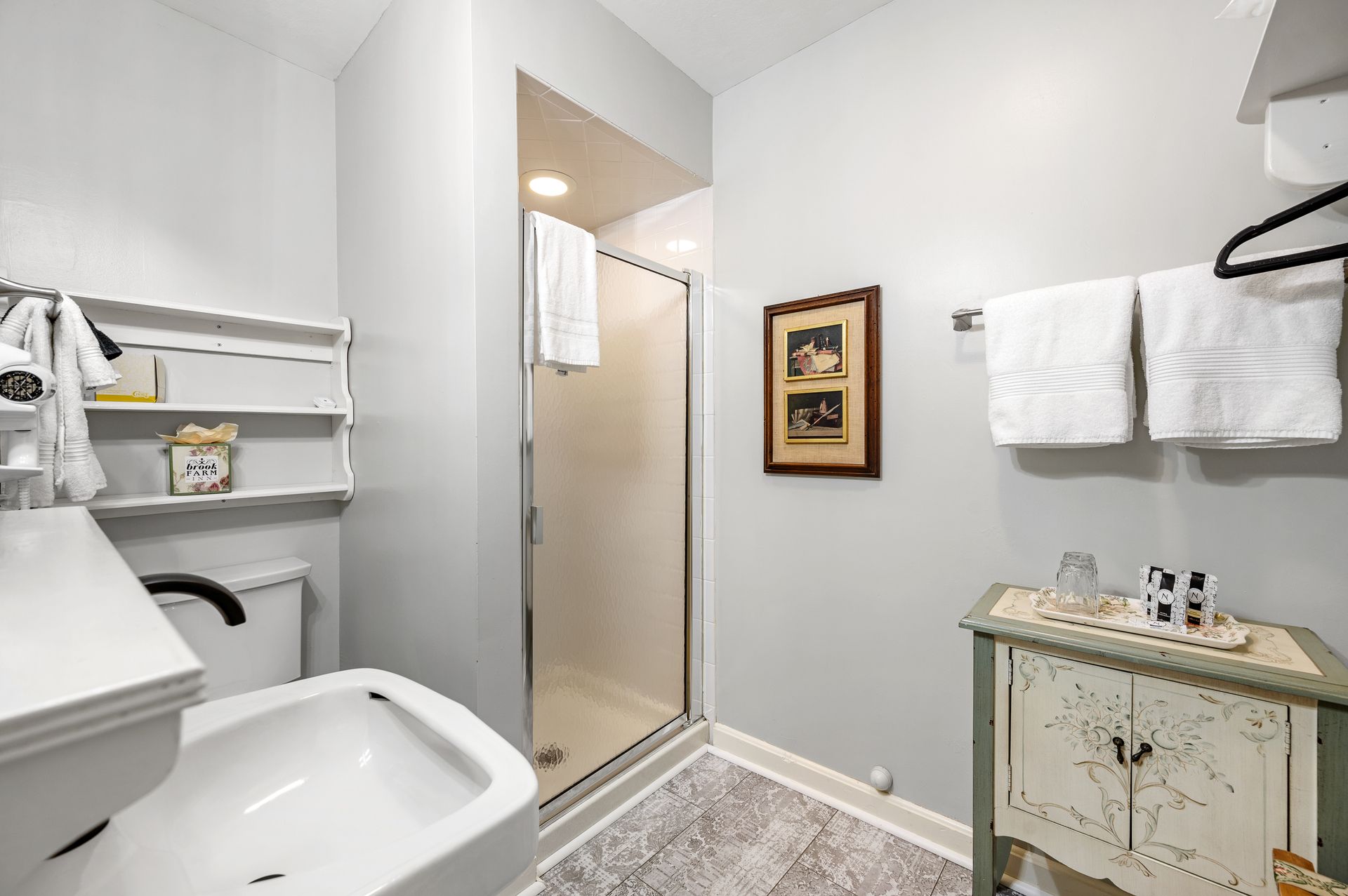 A bathroom with a toilet , sink , and shower.