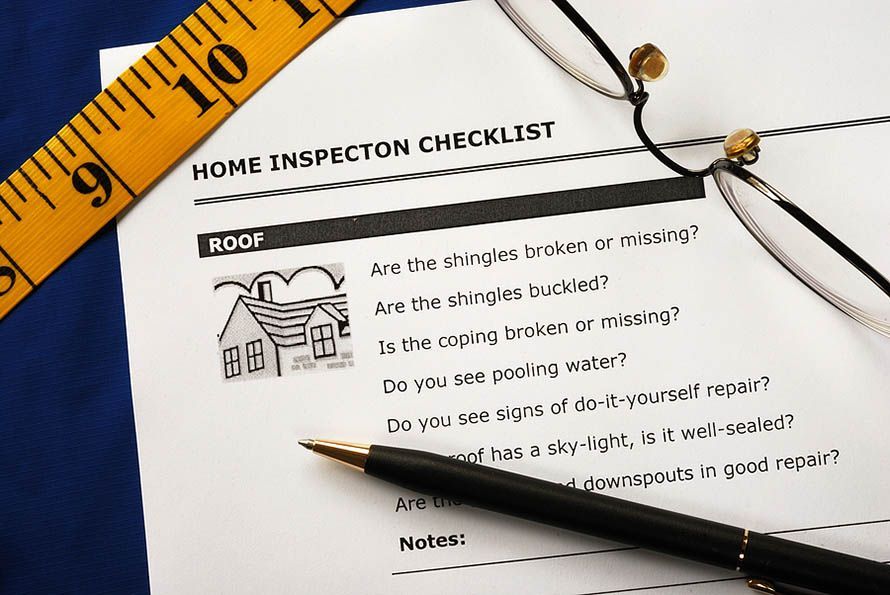 Home inspection checklist for roof evaluation with illustrative drawing of a house.