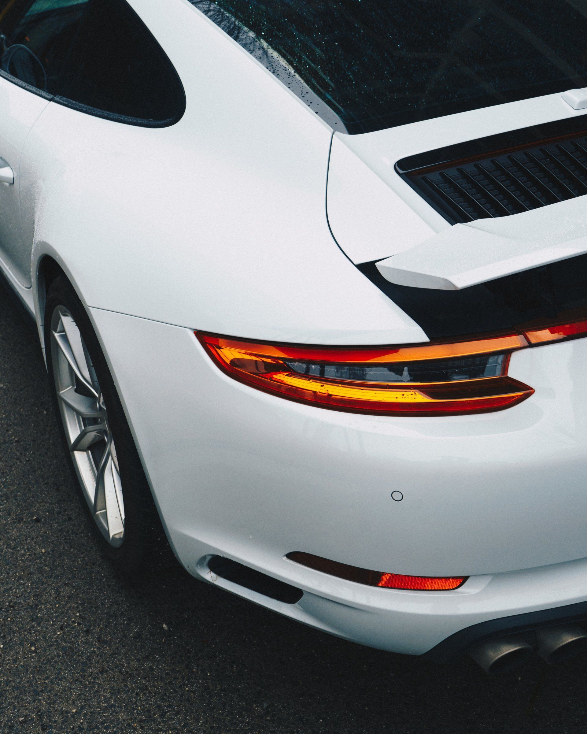 A white sports car is parked on the street - paintless dent removal