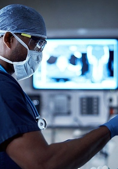 a Cardiologist is looking at an x-ray in the cath lab.