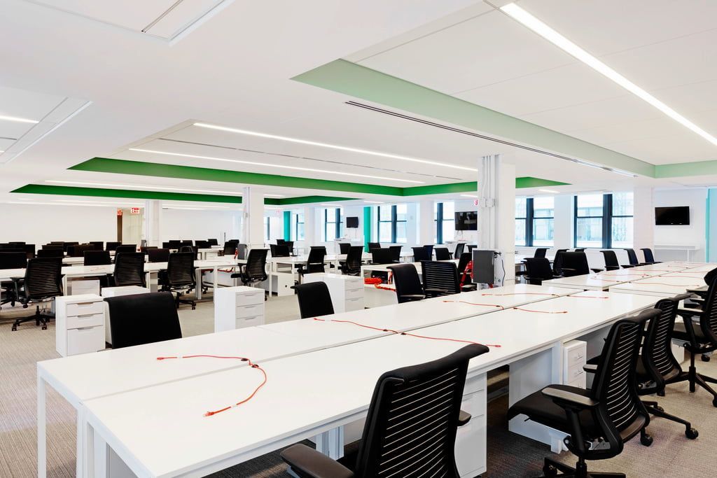 Bright, Open Office Space With Rows of White Desks and Black Chairs — Country Coast Valuers in Cundletown, NSW