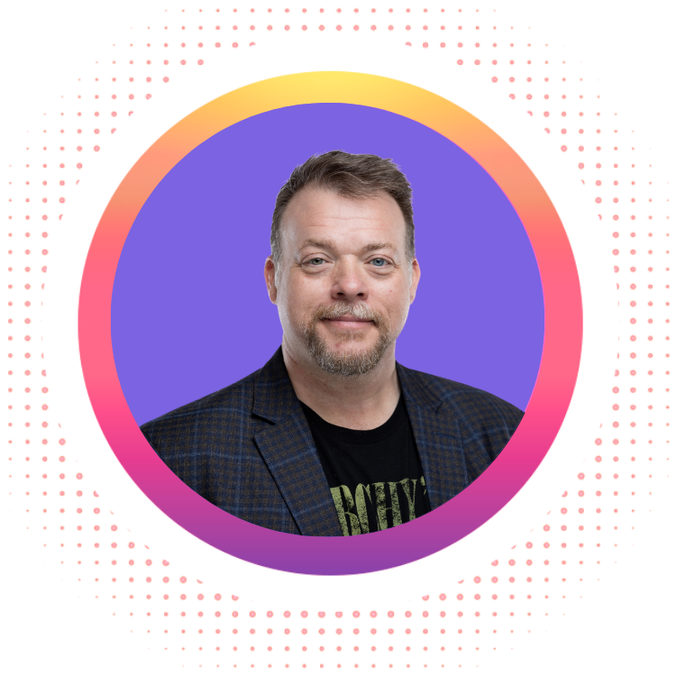 Man in a blazer and t-shirt, smiling, inside a purple and orange circle.
