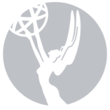 Emmy Award statue in light gray, within a gray circle.