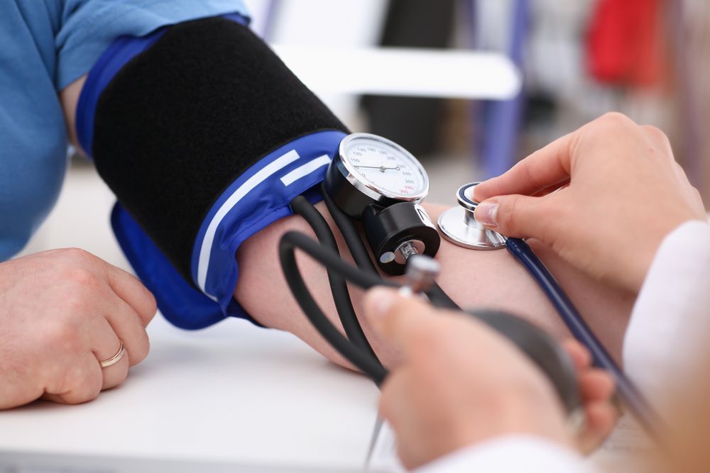 Blood pressure being measured with a cuff and stethoscope on a person’s arm