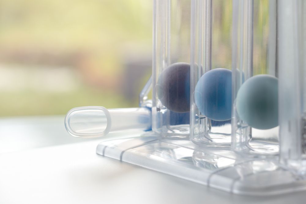 Transparent test tubes and pastel blue balls on a lab tray in soft daylight