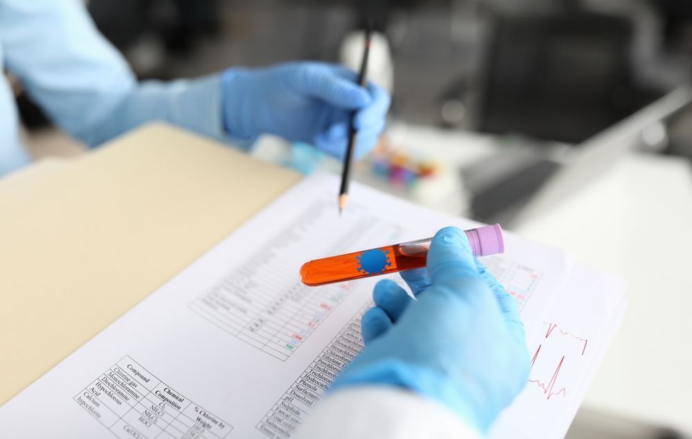 Gloved hands marking documents with a pen and orange highlighter on a desk