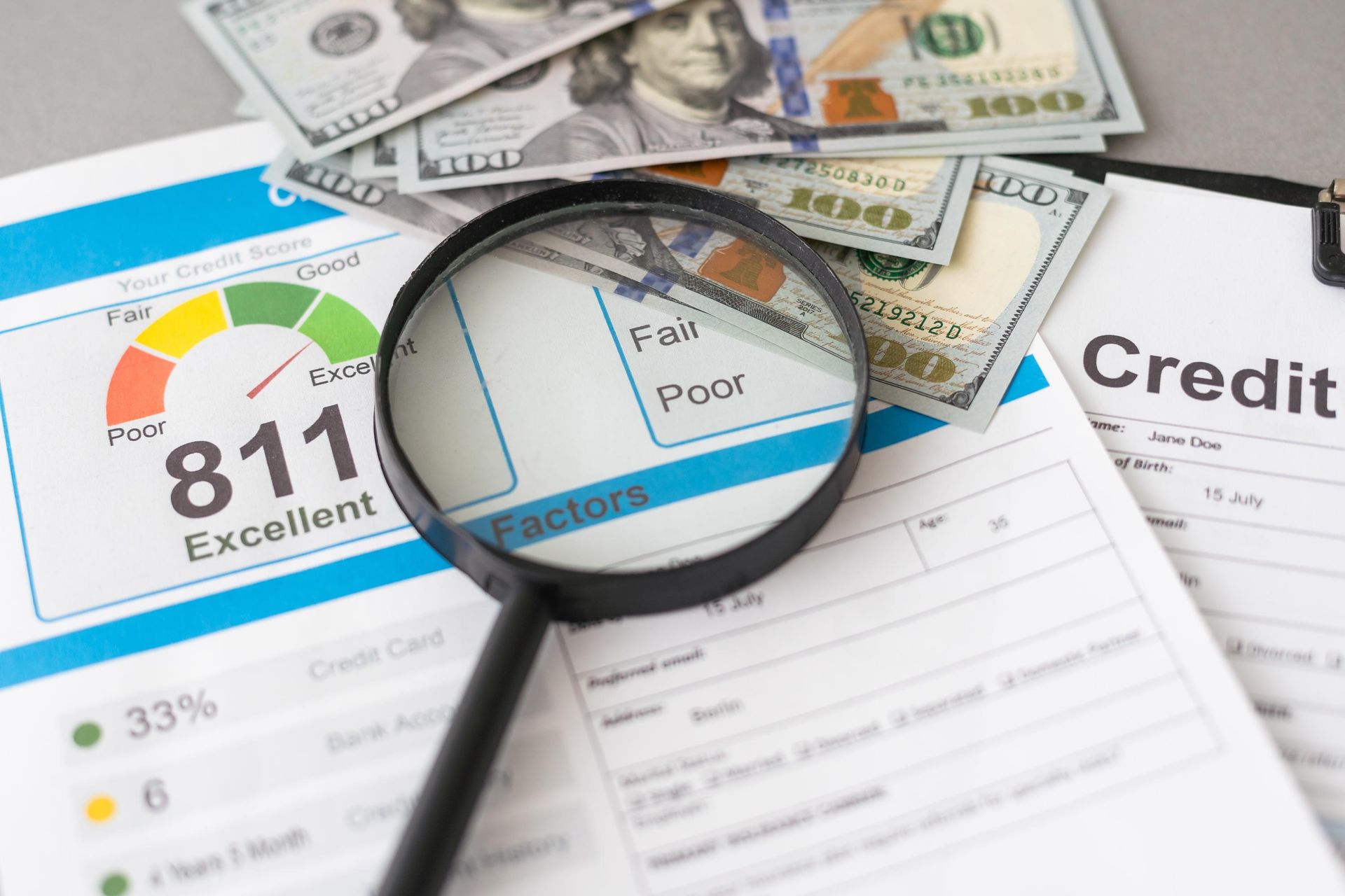 Credit score report with magnifying glass, bills, and dollar notes