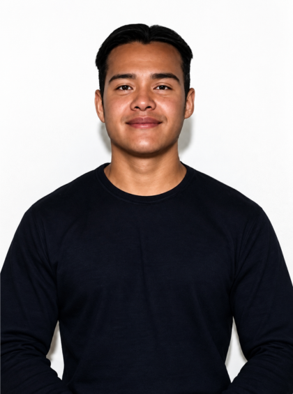 Person in a black shirt smiling against a plain white background