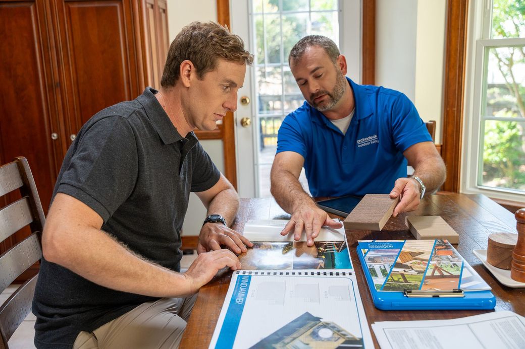 Project manager reviewing plans with homeowner on construction site
