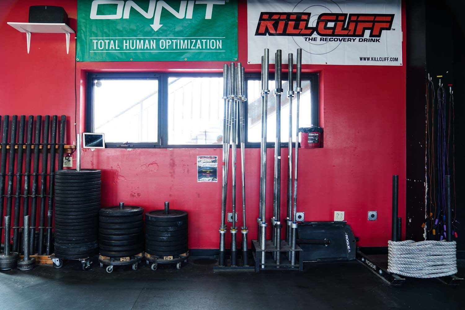A gym with a sign on the wall that says onnit