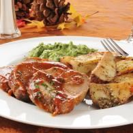 Plated steak with sauce, mashed potatoes, and broccoli on a white dish
