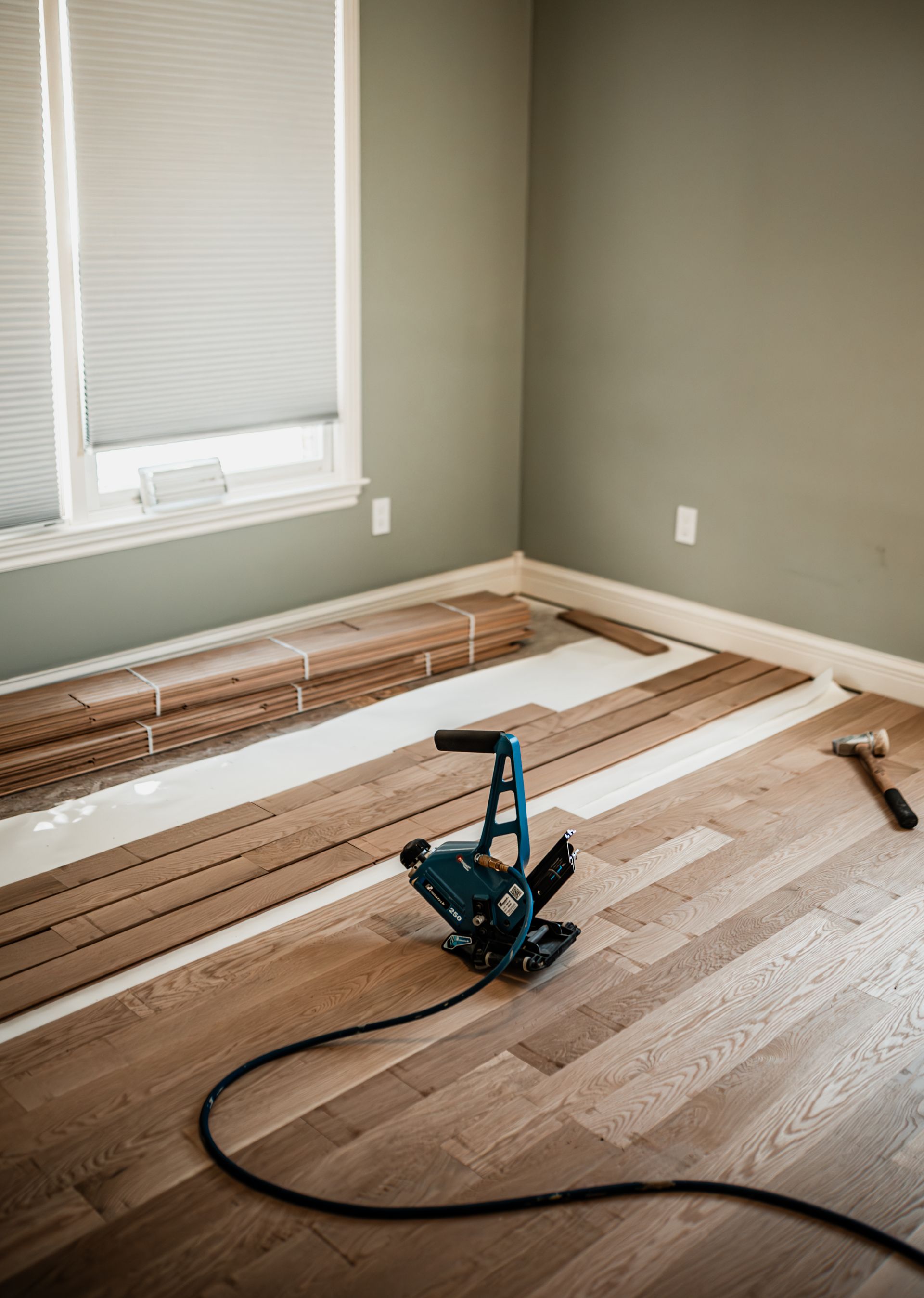 A machine is sitting on a wooden floor in a room.