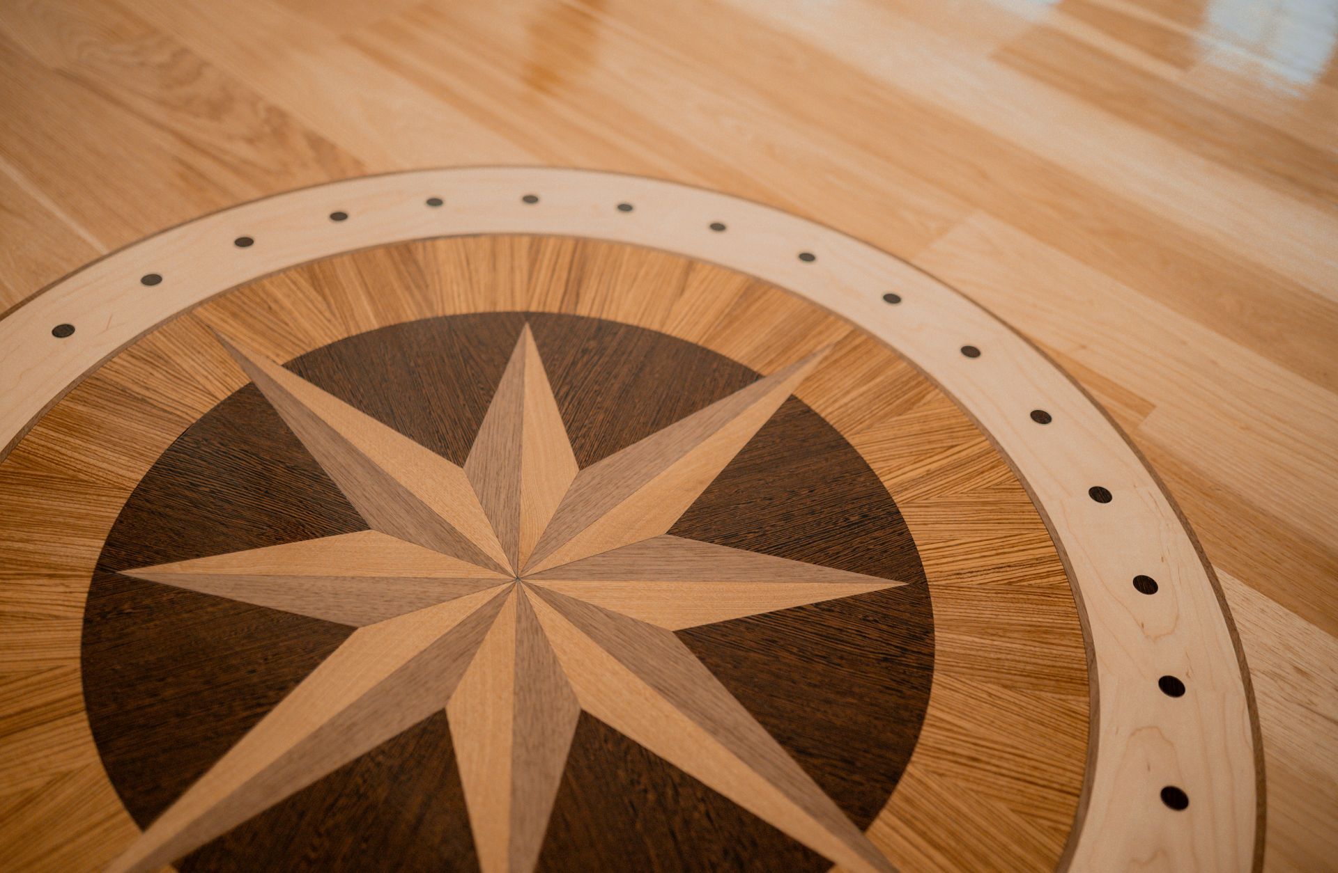 A wooden floor with a circular pattern on it