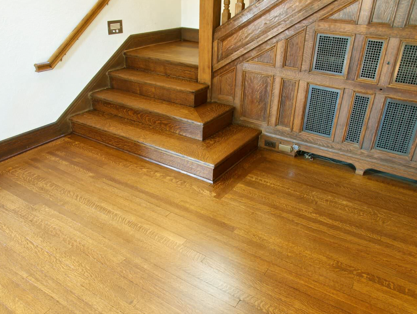 A wooden staircase with a wooden railing and a wooden floor