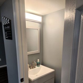 A bathroom with a sink and a mirror.