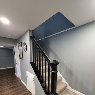 A hallway with stairs leading up to the second floor