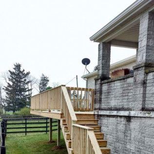 There is a wooden deck with stairs leading up to it.