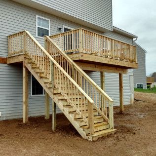 A wooden deck with stairs leading up to it