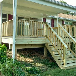 A wooden deck with stairs leading up to it