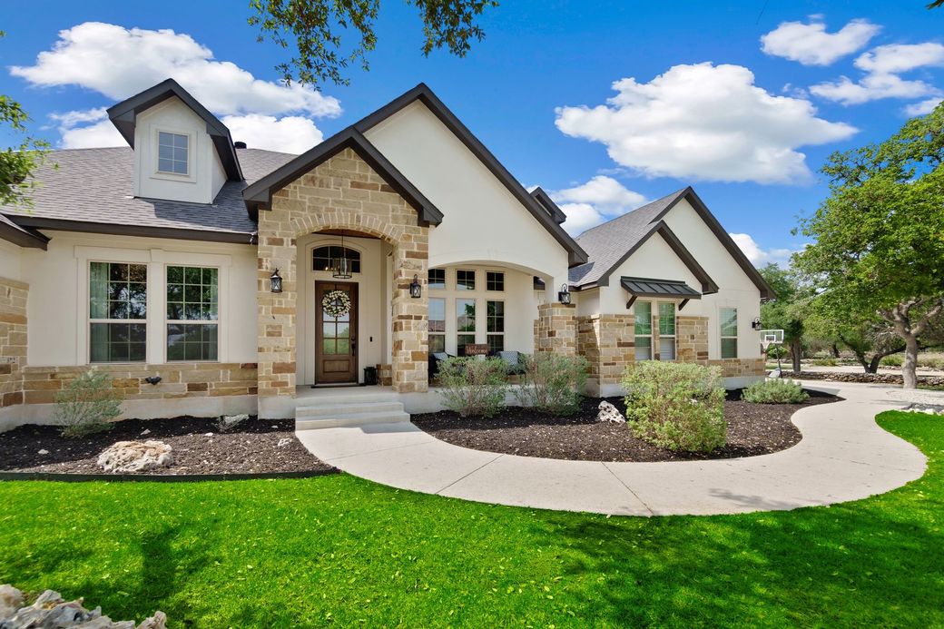 A large house with a lot of windows and a walkway leading to it.