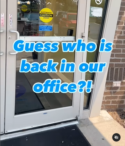 A door with the words guess who is back in our office written on it