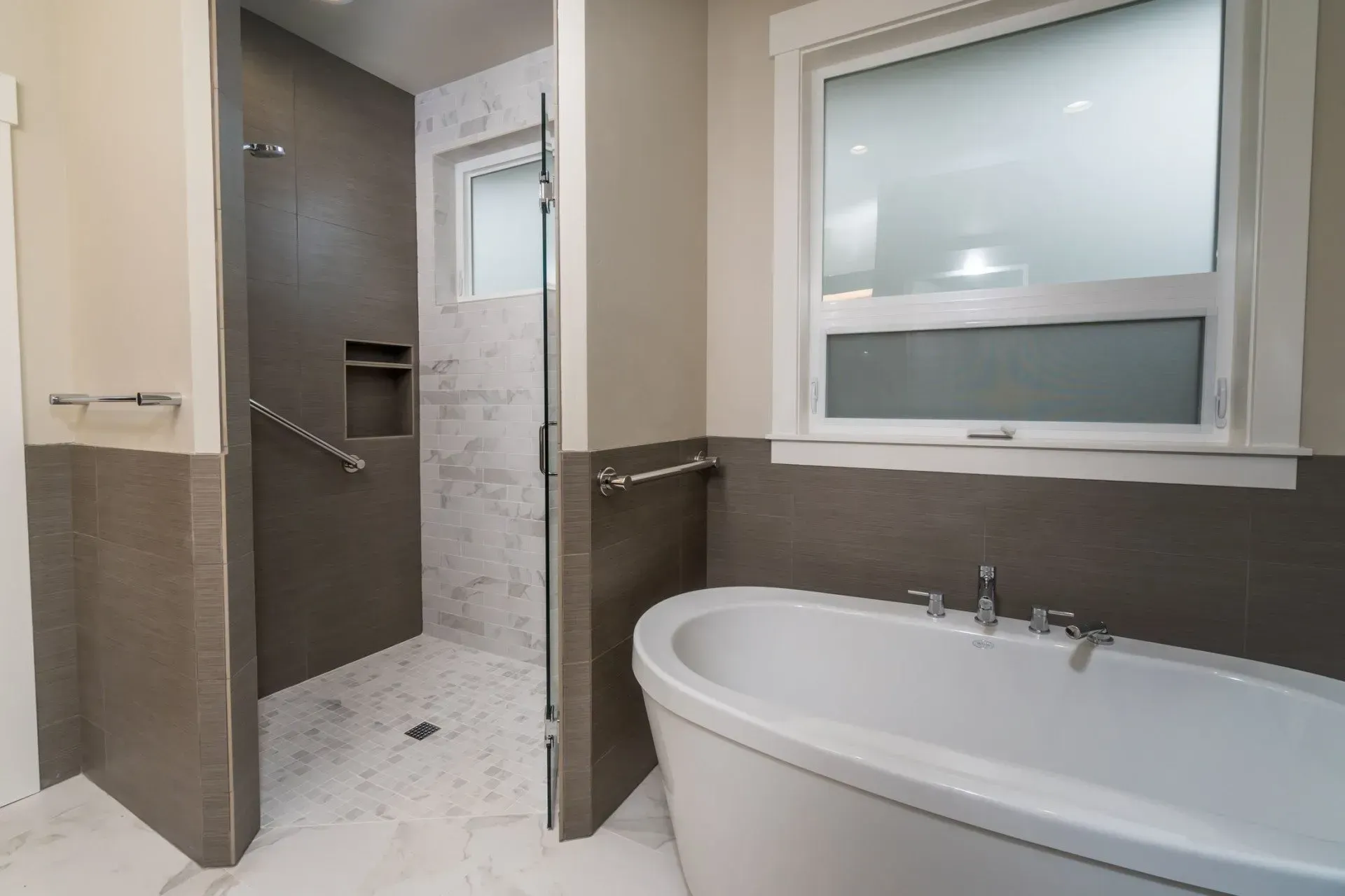 Modern bathroom with walk-in shower, freestanding tub, and large frosted window.