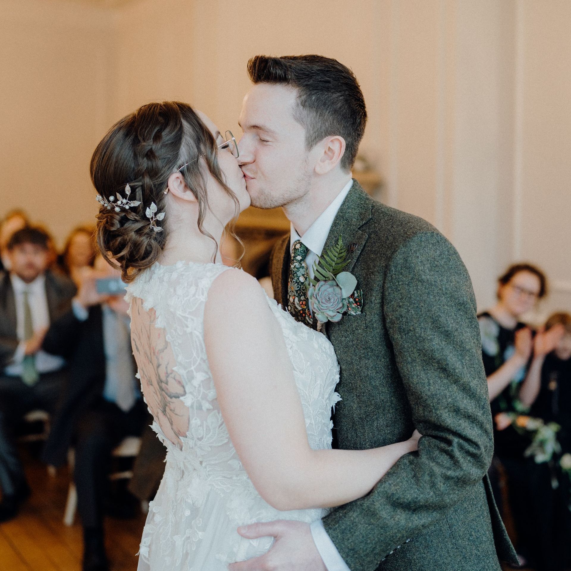 bride and groom wedding kiss with bridal hair and makeup by Jax-Glam Beauty