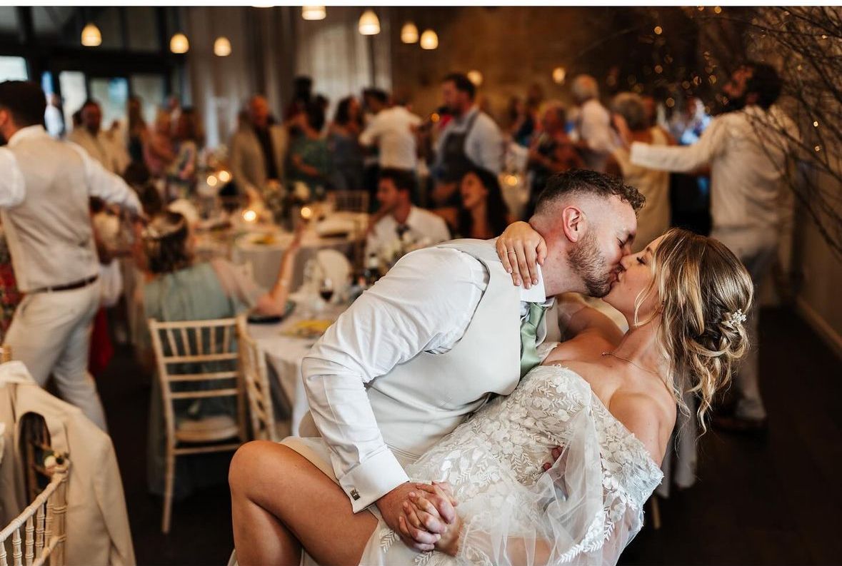 bride and groom first kiss with bridal hair and makeup by Jax-Glam Beauty Bristol