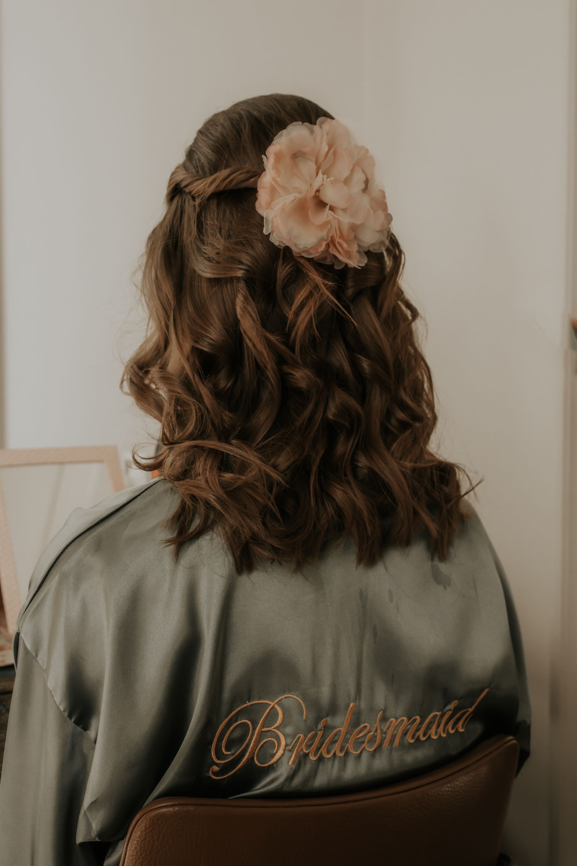 bridesmaid wedding hairstyle with floral hair accessory by Jax-Glam Beauty Bristol