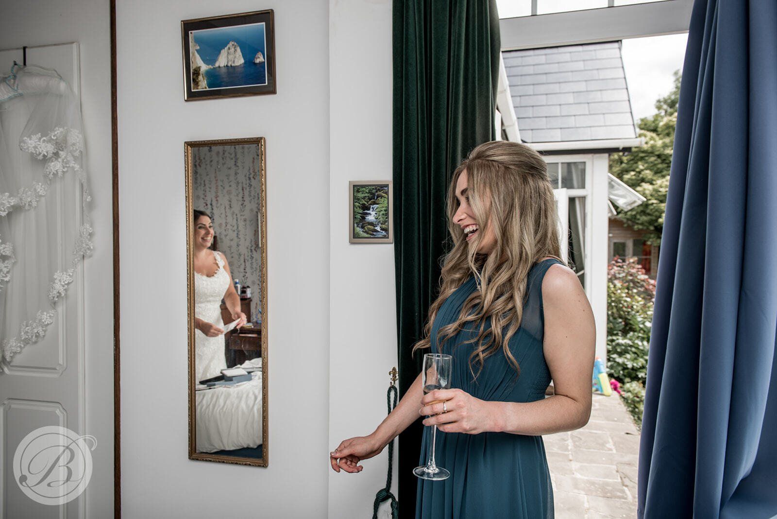bride looking in mirror during wedding preparation with hair and makeup by Jax-Glam Beauty Bristol