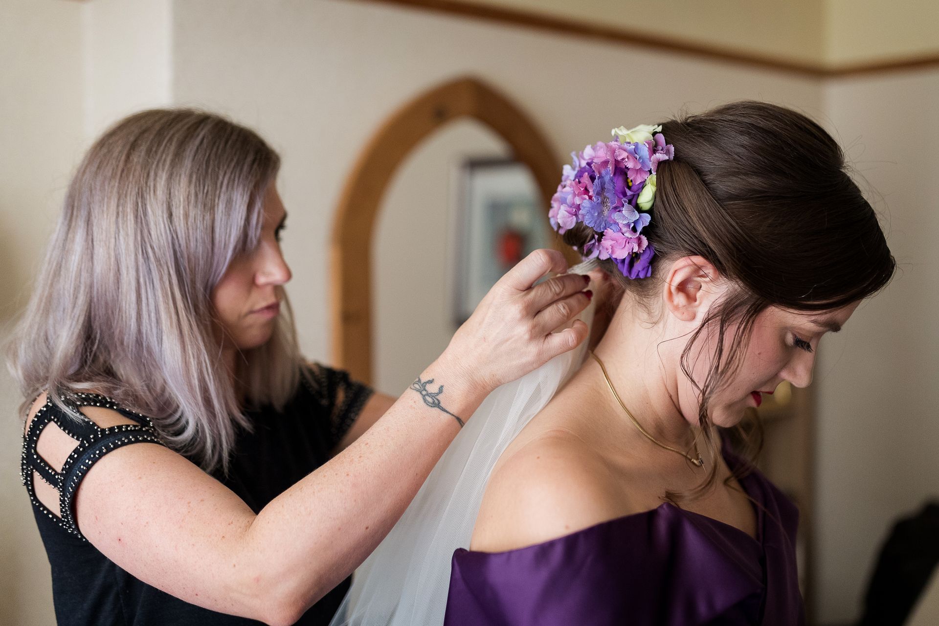 bridal hair flowers being placed by Jax-Glam Beauty wedding stylist Bristol