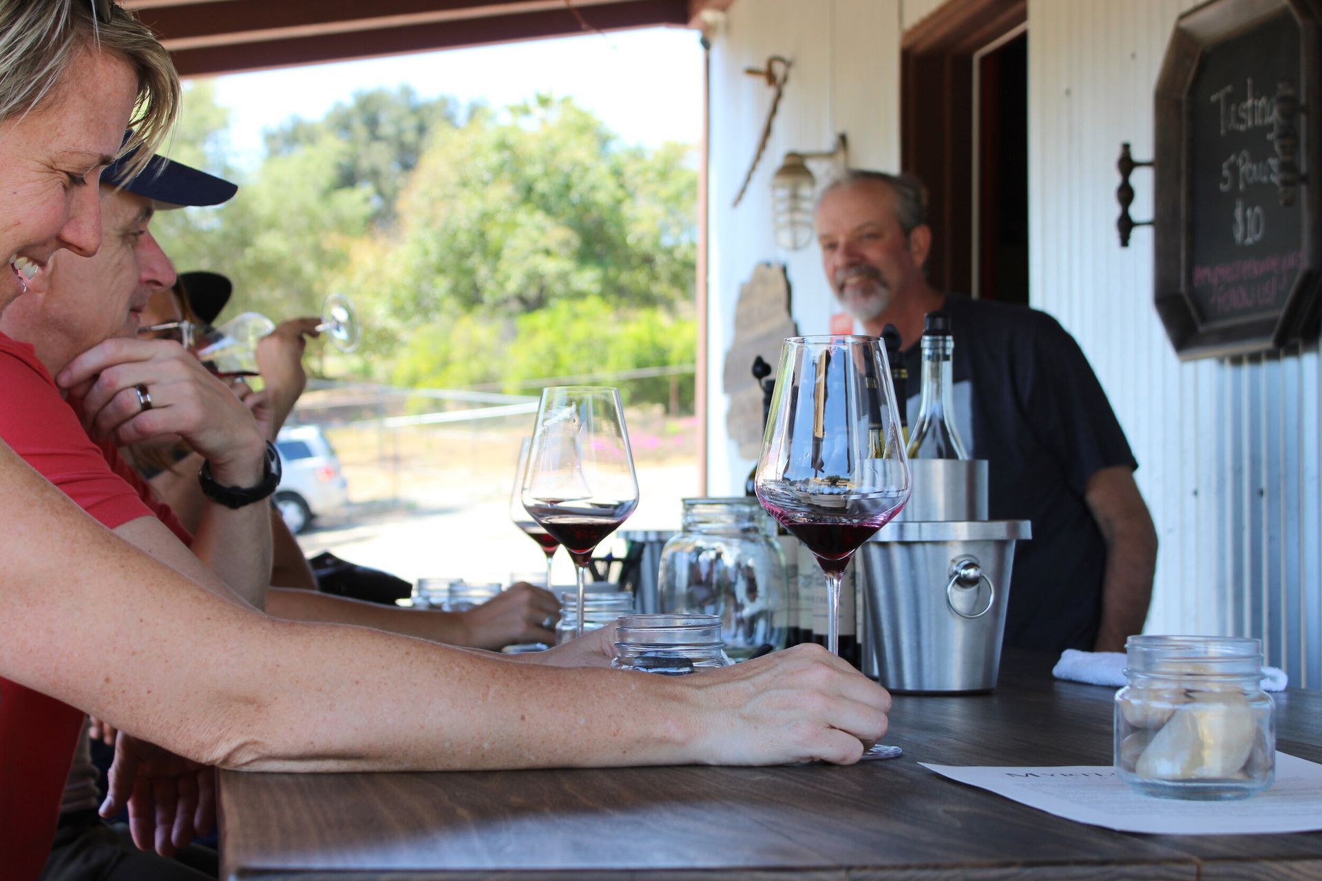 A group of people are sitting at a table drinking wine.