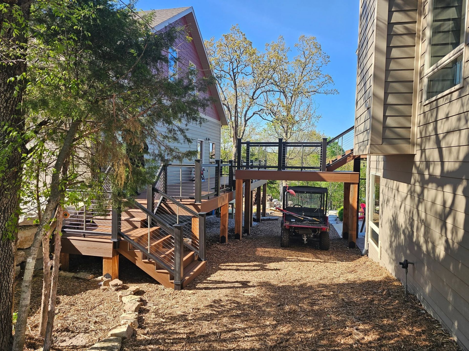 New wooden stairs and railing beside a backyard swimming pool