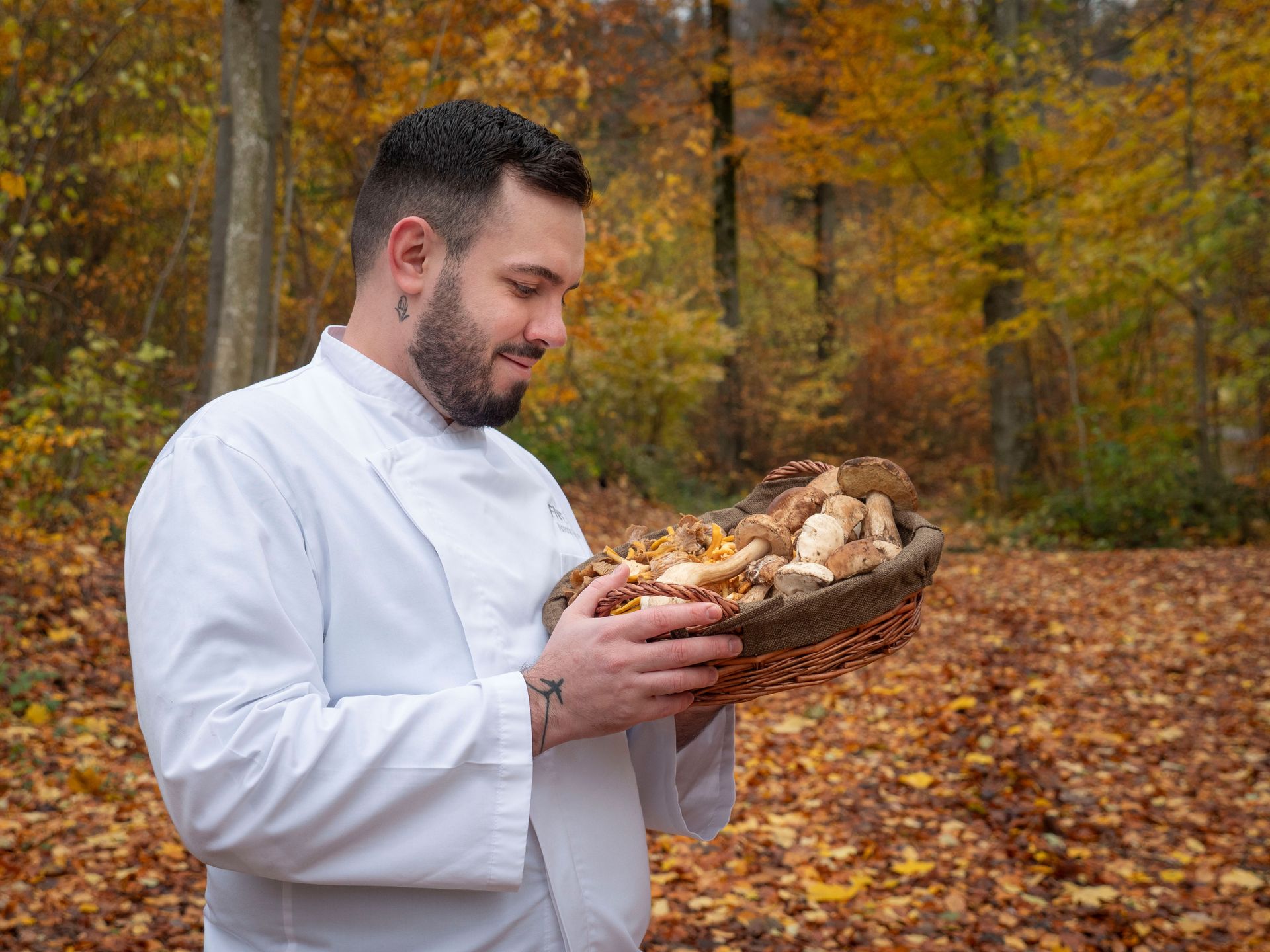 Chef Antonio Satta selecting fresh mushrooms for a private culinary experience
